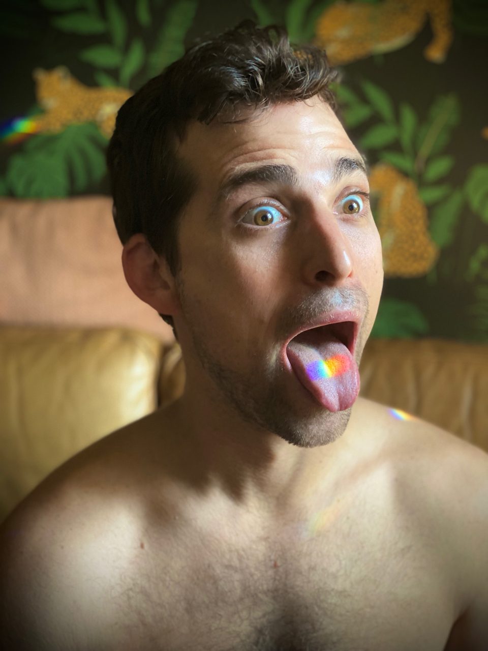 Aaron sticking his tongue out, prism light landing on it
